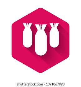 White Aviation bombs icon isolated with long shadow. Rocket bomb flies down. Pink hexagon button. Vector Illustration