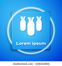 White Aviation bombs icon isolated on blue background. Rocket bomb flies down. Blue square button. Vector Illustration