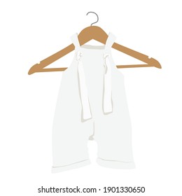 White baby romper on a hanger. Baby boho clothes, abstract boho clothes, cute minimal wear for children. Baby wardrobe, fashion boho outfit in bohemian style. 