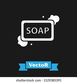 White Bar of soap with foam icon isolated on black background. Soap bar with bubbles.  Vector Illustration