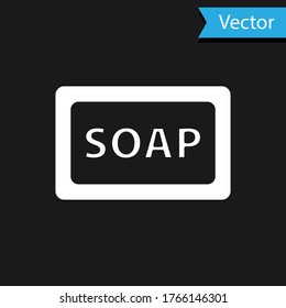 Icono de la barra blanca del jabón aislado en el fondo negro. Barra de jabón con burbujas. Vector.