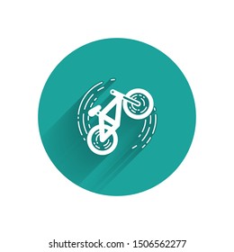 White Bicycle trick icon isolated with long shadow. Bike race. Extreme sport. Sport equipment. Green circle button. Vector Illustration