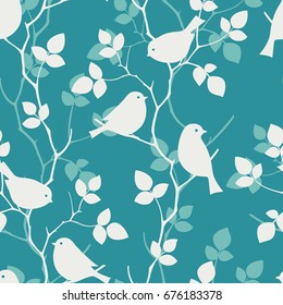 White bird silhouette sitting on branches of tree on blue background. Seamless pattern