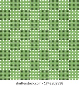 White and black mixed polka dots form a checkered pattern on a green background. Seamless vector stylish illustrations.
