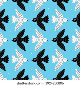White and black pigeons on a blue background.Bird pattern for postcards, decor, textiles, fabric, background, wallpaper, packaging paper.