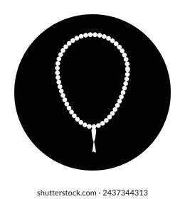 A white and black round pendant with a white bead on a black background