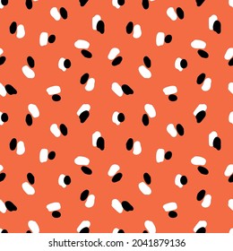 manchas blancas y negras sobre un fondo naranja. Patrón básico sin fisuras. Fondo de fondo para papel pintado, textil, postales, envoltura, etc. 