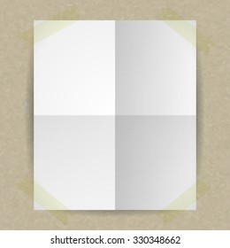White Blank Page background fixed with sticky tape. White sheet of paper with folds glued to the corner of the tape kraft paper. The sheet was folded on the fourth and deployed. Empty sheet of paper