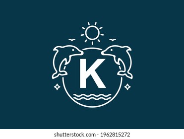 White blue color of K initial letter in dolphin and ocean frame design