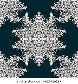 White blue floral ornament in baroque style. Antique white repeatable wallpaper.White element on blue background. Damask pattern repeating background.