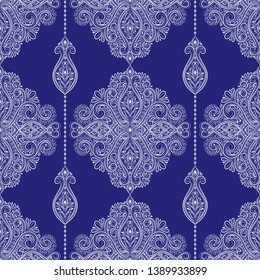 White and blue floral seamless pattern with ornamental stripes. Traditional oriental motifs. Vintage ornament template. Decorative paisley elements. Great for fabric and textile.
