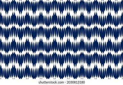 white and blue ikat ethnic design background. Seamless curvy waves ikat pattern in tribal, folk embroidery abstract Japanese wave art. ornament print. Design for carpet, clothing, fashion, fabric.