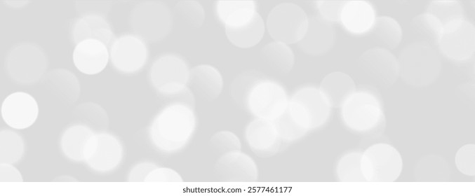 White bokeh, blurred grey background with sparkling lights, blurry glitter effect.