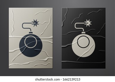 White Bomb ready to explode icon isolated on crumpled paper background. Paper art style. Vector Illustration