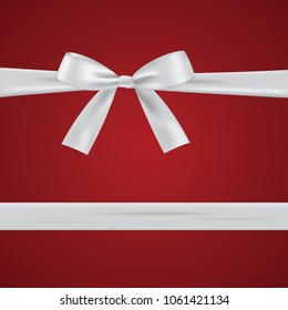 White bow with ribbon isolated on a red background