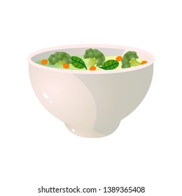 White bowl of green broccoli soup with fresh carrot