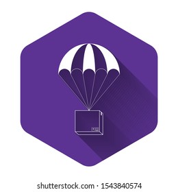 White Box flying on parachute icon isolated with long shadow. Parcel with parachute for shipping. Delivery service, air shipping concept, bonus concept. Purple hexagon button. Vector Illustration