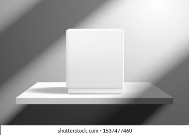 A white box stands on a shelf near an empty wall. Light from the window creates oblique shadows. Template for design