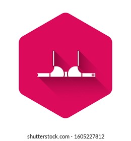 White Bra icon isolated with long shadow. Woman underwear. Pink hexagon button. Vector Illustration