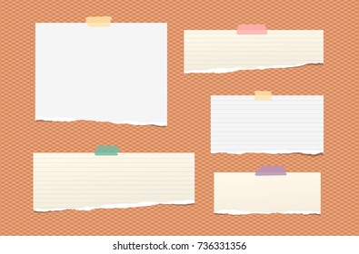 White and brown ripped lined paper strips, notebook, note for text or message stuck with colorful sticky tape on orange squared background.