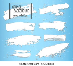White brush strokes on a blue background, ink brush strokes, brushes, lines. Dirty artistic design elements, boxes, frames.
