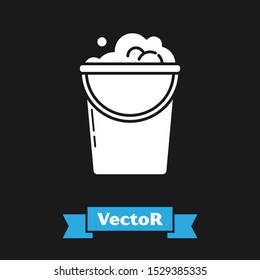 White Bucket with foam and bubbles icon isolated on black background. Cleaning service concept.  Vector Illustration