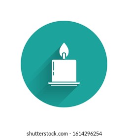 White Burning candle in candlestick icon isolated with long shadow. Cylindrical candle stick with burning flame. Green circle button. Vector Illustration