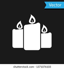 White Burning candles icon isolated on black background. Old fashioned lit candles. Cylindrical aromatic candle sticks with burning flames. Vector Illustration