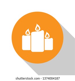White Burning candles icon isolated on white background. Old fashioned lit candles. Cylindrical aromatic candle sticks with burning flames. Orange circle button. Flat design. Vector Illustration
