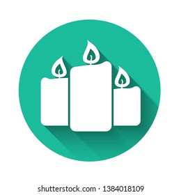 White Burning candles icon isolated with long shadow. Old fashioned lit candles. Cylindrical aromatic candle sticks with burning flames. Green circle button. Vector Illustration