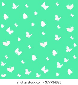 White butterflies on a green background.