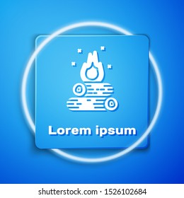 White Campfire icon isolated on blue background. Burning bonfire with wood. Blue square button. Vector Illustration