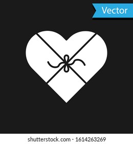 White Candy in heart shaped box and bow icon isolated on black background. Valentines Day.  Vector Illustration