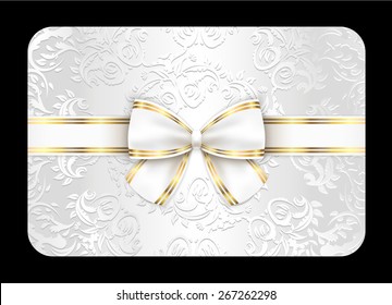 White card with ornament and white ribbon