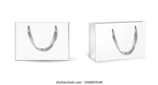 White cardboard bags set. Blank gift or shopping packages with ribbon handles vector illustration. Two realistic commercial store carton bags isolated on white background.