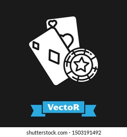 White Casino chip and playing cards icon isolated on black background. Casino poker.  Vector Illustration