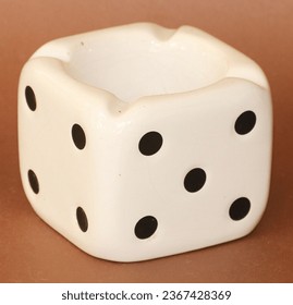 White ceramic ashtray on white background. Dice shaped ashtray