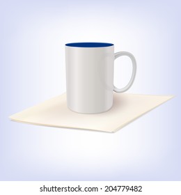 White ceramic cup standing on a napkin. Template for your design.