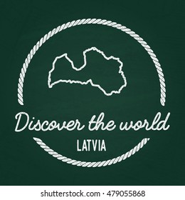 White chalk texture hipster insignia with Republic of Latvia map on a green blackboard. Grunge rubber seal with country outlines, vector illustration.