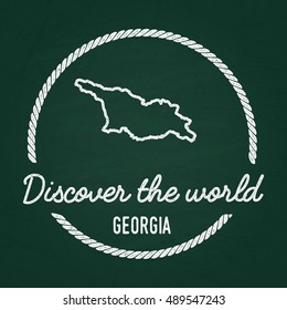 White chalk texture hipster insignia with Georgia map on a green blackboard. Grunge rubber seal with country outlines, vector illustration.