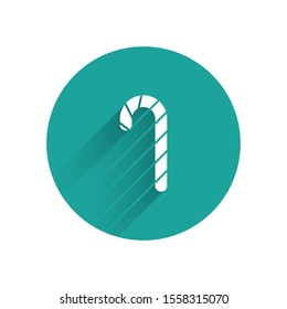 White Christmas candy cane with stripes icon isolated with long shadow. Merry Christmas and Happy New Year. Green circle button. Vector Illustration