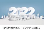 
White Christmas village with trees and houses under 2022 new year typography.
