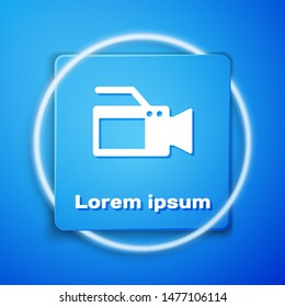 White Cinema camera icon isolated on blue background. Video camera. Movie sign. Film projector. Blue square button. Vector Illustration