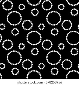 White circles on black background. Seamless pattern. Vector image.