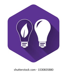 White Classic Lamp and Light bulb with leaf inside icon isolated with long shadow. Lighting electric lamp. Green eco energy concept. Purple hexagon button. Vector Illustration