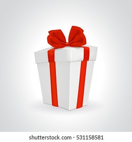 White closed gift box with red ribbon and bow.