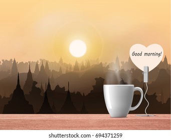 white coffee cup on wood table over sunset view 
