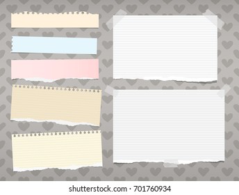 White and colorful ripped ruled, striped note, copybook, notebook paper stuck on background created of hearts shape.