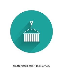 White Container on crane icon isolated with long shadow. Crane lifts a container with cargo. Green circle button. Vector Illustration