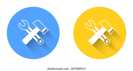 White Crossed hammer and wrench spanner icon isolated with long shadow background. Hardware tools. Circle button. Vector